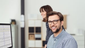 Mann und Frau vor einem PC am arbeiten